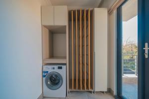 a laundry room with a washing machine and a door at Luku Villa in Sapanca
