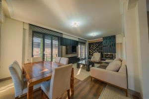 a living room with a wooden table and a dining room at Luku Villa in Sapanca
