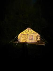 a kite sitting on a table in the dark at Fyn Glamping in Nyborg +3 photos