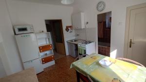 a small kitchen with a table and a counter top at Dům in Hrabowa