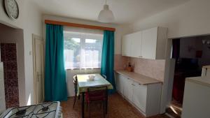a small kitchen with a table and a window at Dům in Hrabowa