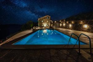 a swimming pool at night with a starry sky at Villa Eremo Cinque Terre in Castiglione Chiavarese