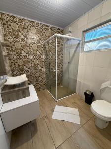 a bathroom with a shower and a toilet at Hotel e Restaurante Santa Fé in Lages +67 photos