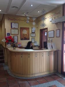 a woman sitting at a counter in a restaurant at Hotel Casona de la Reyna in Toledo