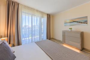 a bedroom with a bed and a large window at Infinity View 3 Shkorpilovci in Shkorpilovtsi +20 photos