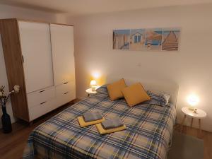 a bedroom with a bed with two pillows on it at Garden apartment Vanya in Split