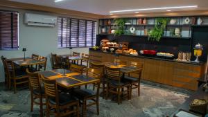 a restaurant with wooden tables and a bar at Nohotel Nova Odessa in Nova Odessa