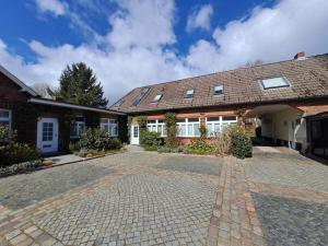 a brick driveway in front of a house at Landhaus Gerdts - 1 in Cuxhaven