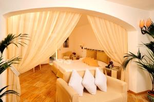a bedroom with a bed with white pillows at Le Calette Bay in Cefalù
