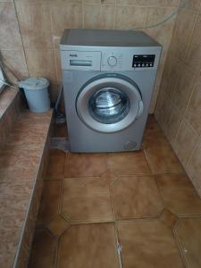 a washing machine in a bathroom with a tile floor at Happy house in Kobuleti