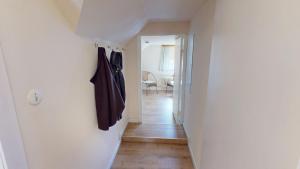 a hallway with a white wall with a coat rack at Landhaus Gerdts - 4 in Cuxhaven