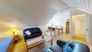 a living room with a couch and a table at Landhaus Gerdts - 4 in Cuxhaven