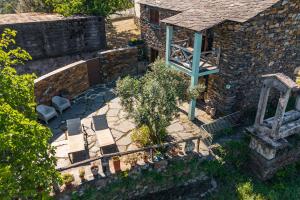 an overhead view of a garden with a tree and a building at Casa da Figueira - Rio Paiva in Arouca