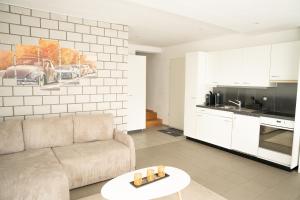 a living room with a couch and a kitchen at Ufer Nest in Buochs in Buochs