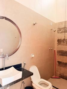 a bathroom with a toilet and a sink and a shower at Pouso Mineiro in São João Batista do Glória +20 photos