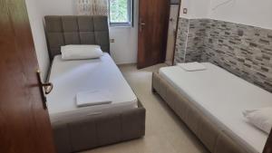 a room with two beds and a door to a bedroom at Guest House Kocollari in Gjirokastër +45 photos