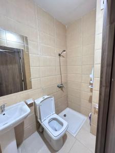 a bathroom with a toilet and a sink at Rmilate Coast Apartment in Asilah +34 photos