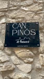a sign on the side of a stone wall at CAN PINÓS de GUIMERÀ in Guimerá