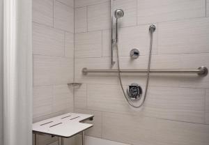 a bathroom with a shower with a shower curtain at Courtyard by Marriott Boston Brookline in Brookline