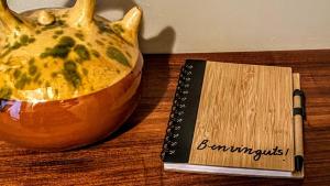 a bowl of food sitting next to a book at CAN PINÓS de GUIMERÀ in Guimerá