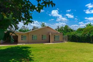 a house with a green lawn in front of it at Faraja House in Maragoli
