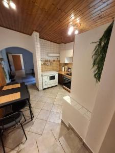 a kitchen with a dining table and a kitchen with a stove at Cozy Cottage in Nature in Bernstein