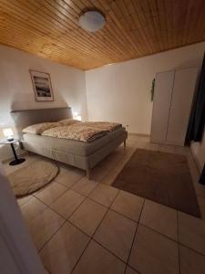 a bedroom with a bed and a wooden ceiling at Cozy Cottage in Nature in Bernstein