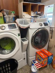 two washing machines sitting next to each other in a kitchen at Waterfront home in Gig Harbor