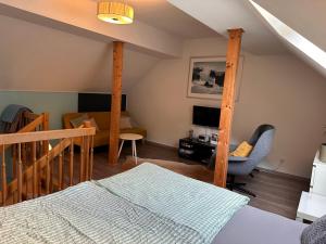 a bedroom with a loft bed and a desk at Ferienwohnung Westerburg in Westerburg