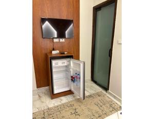 a kitchen with a refrigerator in a room at Hermes On The Spot Pyramids Hotel in Cairo