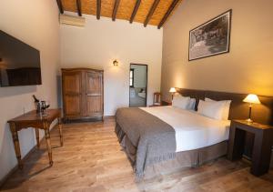 a bedroom with a large bed and a wooden floor at Postales by DOT Boutique in Colonia Las Rosas +37 photos