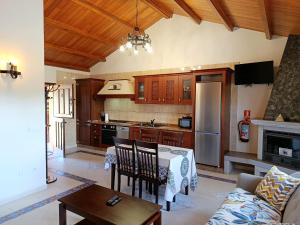 a kitchen with a table and chairs and a couch at Apartamentos Navalin in Tapia de Casariego