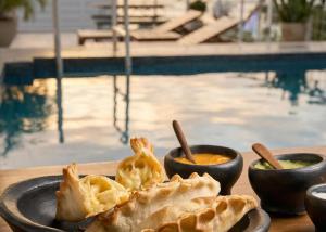 a plate of food on a table next to a pool at MuchoSur Santa Marta in Santa Marta +64 photos