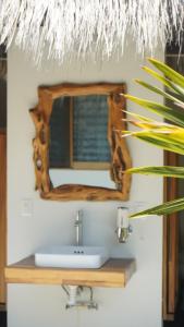 a bathroom with a sink and a mirror at Casa Mario Alberto - Oceanfront Bungalows in Puerto Ángel +33 photos