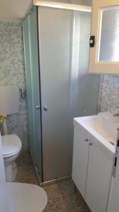 a bathroom with a shower and a toilet and a sink at Le Mura Holiday Home in Marina di Pietrasanta