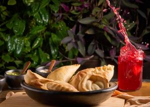 a bowl of food sitting on a table with chips at MuchoSur Santa Marta in Santa Marta