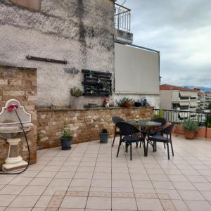 a patio with a table and chairs and a whiteboard at Evi's balcony in Karditsa