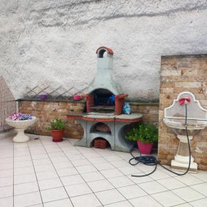 a patio with a pizza oven and a sink at Evi's balcony in Karditsa