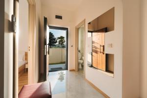 a hallway of a house with a view of a bathroom at Apartments BUBBLES with pool in Gevgelija