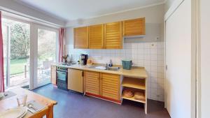 a kitchen with a sink and a counter top at Landhaus Gerdts - 5 in Cuxhaven