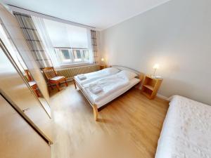 a small bedroom with two beds and a window at Landhaus Gerdts - 5 in Cuxhaven
