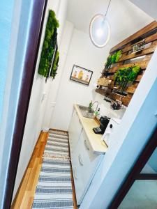 a stairway leading up to a kitchen in a tiny house at Apartament Gossip XOXO in Galaţi