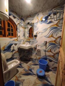a bathroom with a sink and a toilet at HOTEL FABULOUS KASHMIR, Dal lake in Srinagar +43 photos