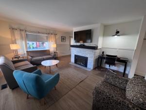 a living room with a couch and a fireplace at Shoreline Resort Condominiums in Penticton