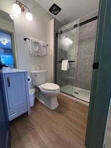a bathroom with a toilet and a glass shower at Shoreline Resort Condominiums in Penticton +52 photos