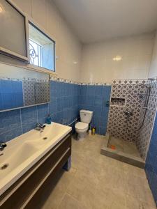 a bathroom with a sink and a toilet and a shower at Villa Pieds dans l eau entre Lagune et Montagne in Ghār al Milḩ +81 photos