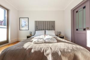 a bedroom with a large bed with two pillows on it at House of Zen - Apartament z widokiem na Motławę i Stare Miasto in Gdańsk +23 photos