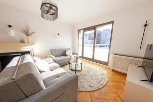 a living room with a couch and a fireplace at House of Zen - Apartament z widokiem na Motławę i Stare Miasto in Gdańsk