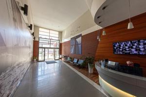 a lobby with a bar with wine bottles on the wall at House of Zen - Apartament z widokiem na Motławę i Stare Miasto in Gdańsk