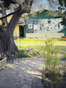 a mural on the side of a building with a tree at alloggio turistico Castel di Salce in Viterbo +2 photos